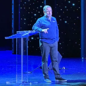 Mike Fabarez standing and speaking on a stage